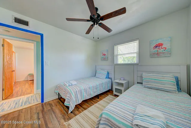 a bedroom with two beds and a window