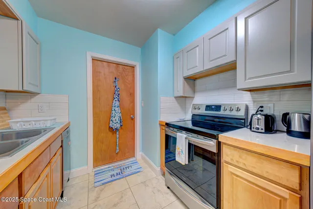 a kitchen with stainless steel appliances granite countertop a stove and a sink