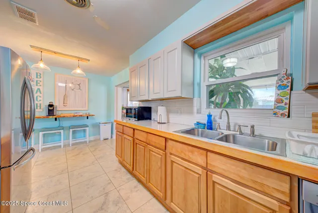 a kitchen with stainless steel appliances a sink and cabinets