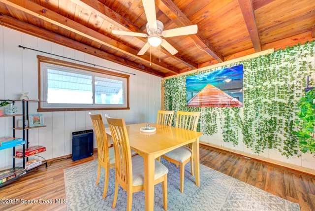a dining room with furniture and a garden view
