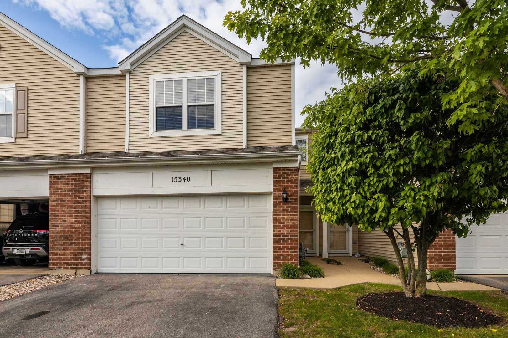 15340 Kenmare Circle Manhattan, IL 60442 - Photo 1 of 19 a front view of a house with a tree