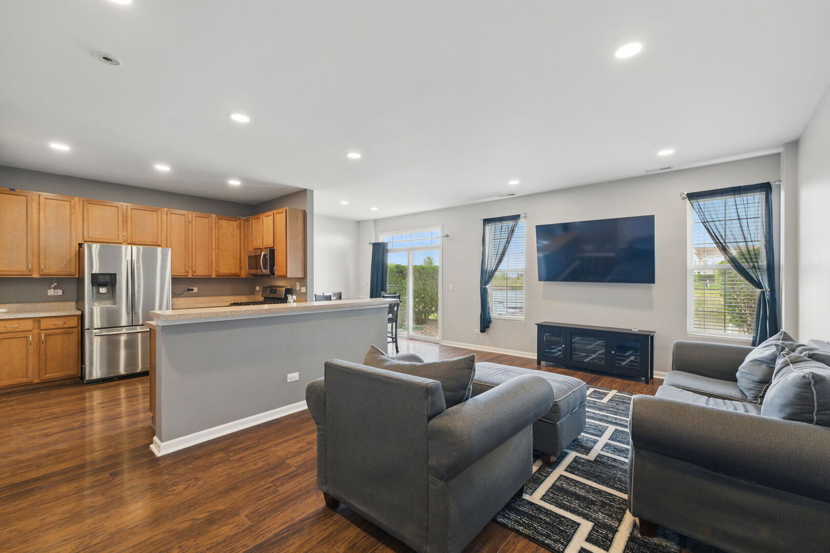 15340 Kenmare Circle Manhattan, IL 60442 - Photo 2 of 19 a living room with furniture a fireplace a flat screen tv and a window