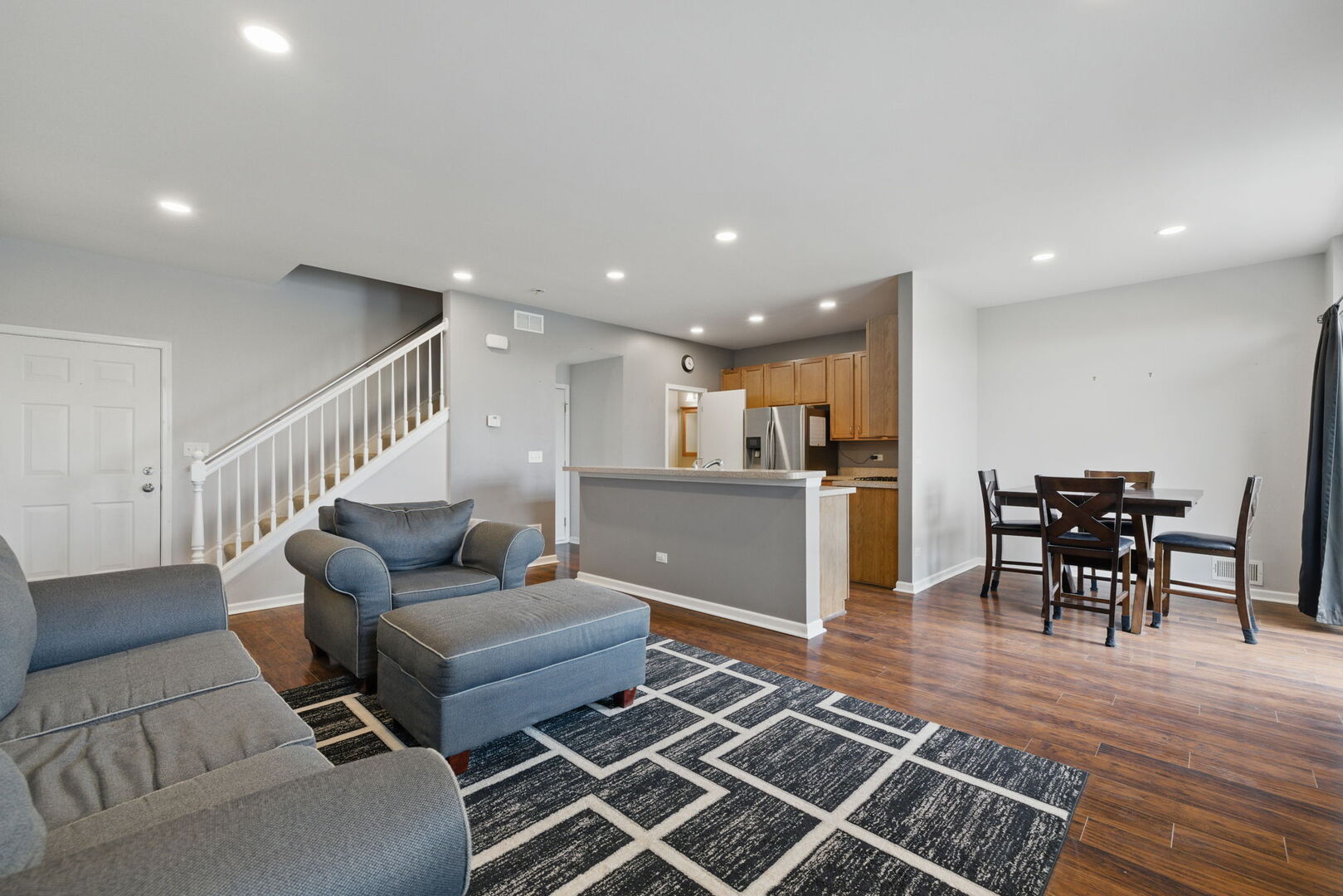 15340 Kenmare Circle Manhattan, IL 60442 - Photo 3 of 19 a living room with furniture and kitchen view with wooden floor