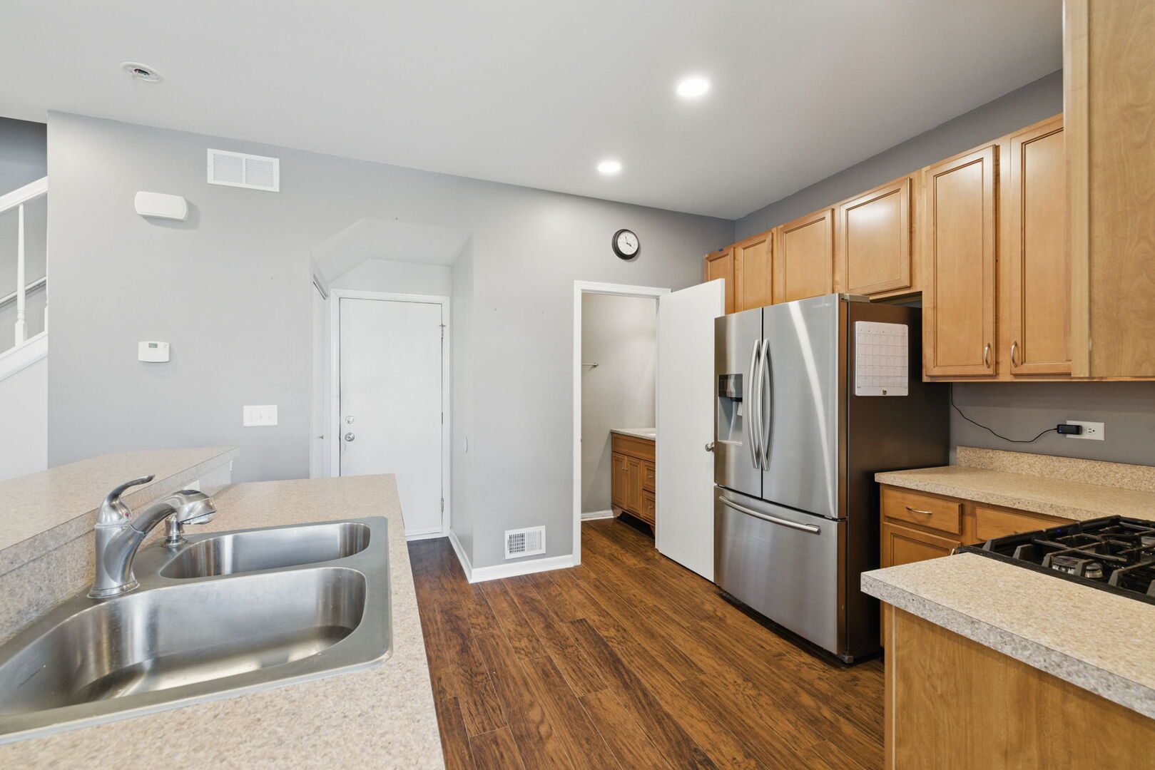 15340 Kenmare Circle Manhattan, IL 60442 - Photo 5 of 19 a kitchen with stainless steel appliances granite countertop a refrigerator sink and wooden cabinets