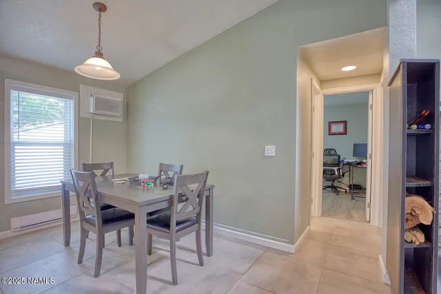 a living room with furniture and a open kitchen view