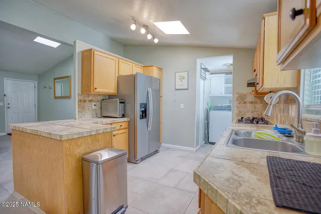 a bathroom with a granite countertop sink mirror vanity and toilet