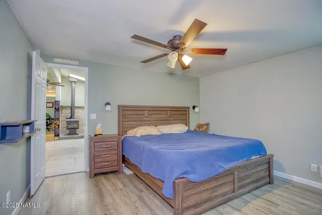 a large bathroom with a sink a mirror a toilet and a shower