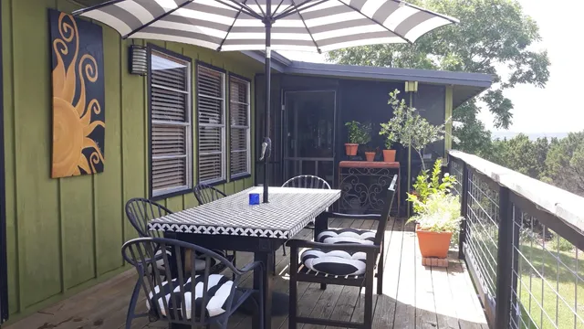 a view of a chairs and tables in the back yard of the house