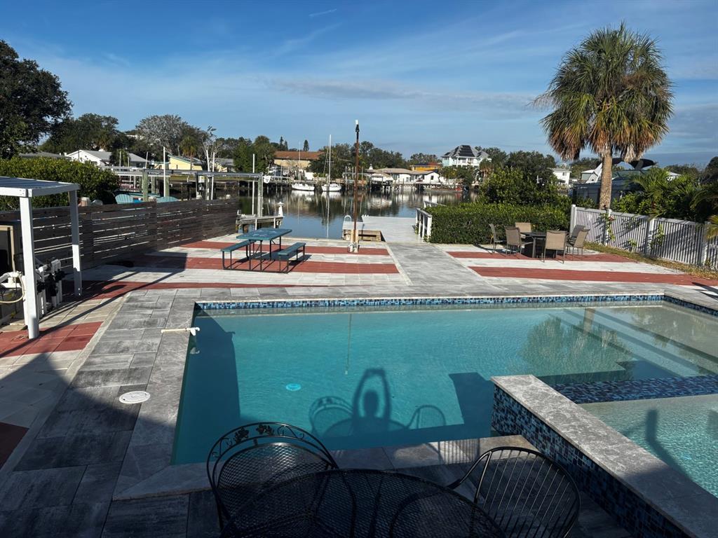 a view of a swimming pool and lounge chairs