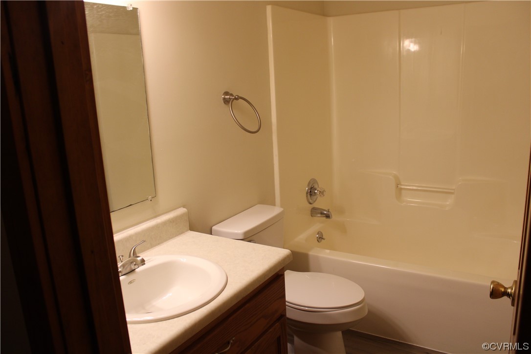 19577 Templeton Road Carson, VA 23830 - Photo 11 of 16 a bathroom with a granite countertop toilet a sink and a bathtub
