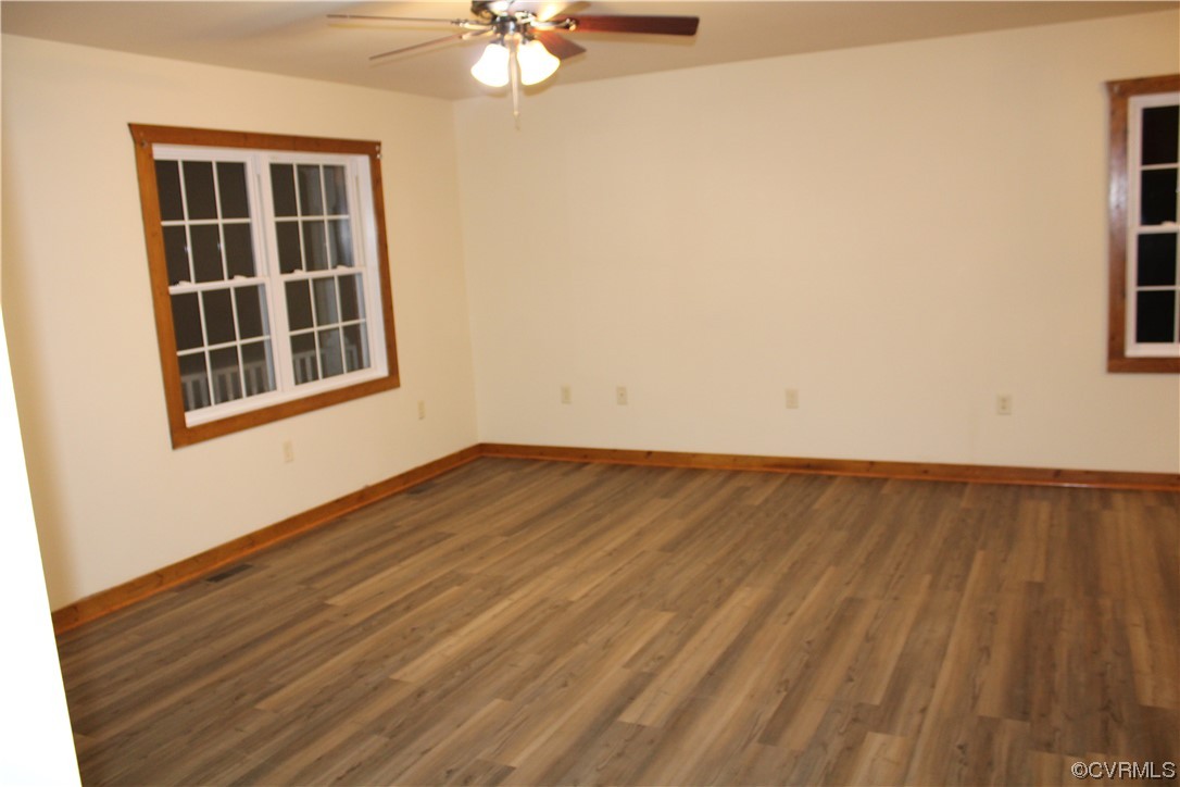 19577 Templeton Road Carson, VA 23830 - Photo 2 of 16 an empty room with wooden floor and windows