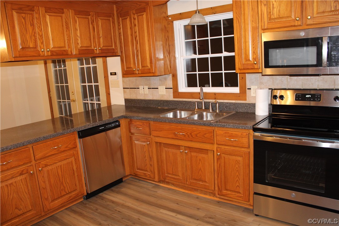19577 Templeton Road Carson, VA 23830 - Photo 4 of 16 a kitchen with granite countertop wooden cabinets stainless steel appliances and a sink