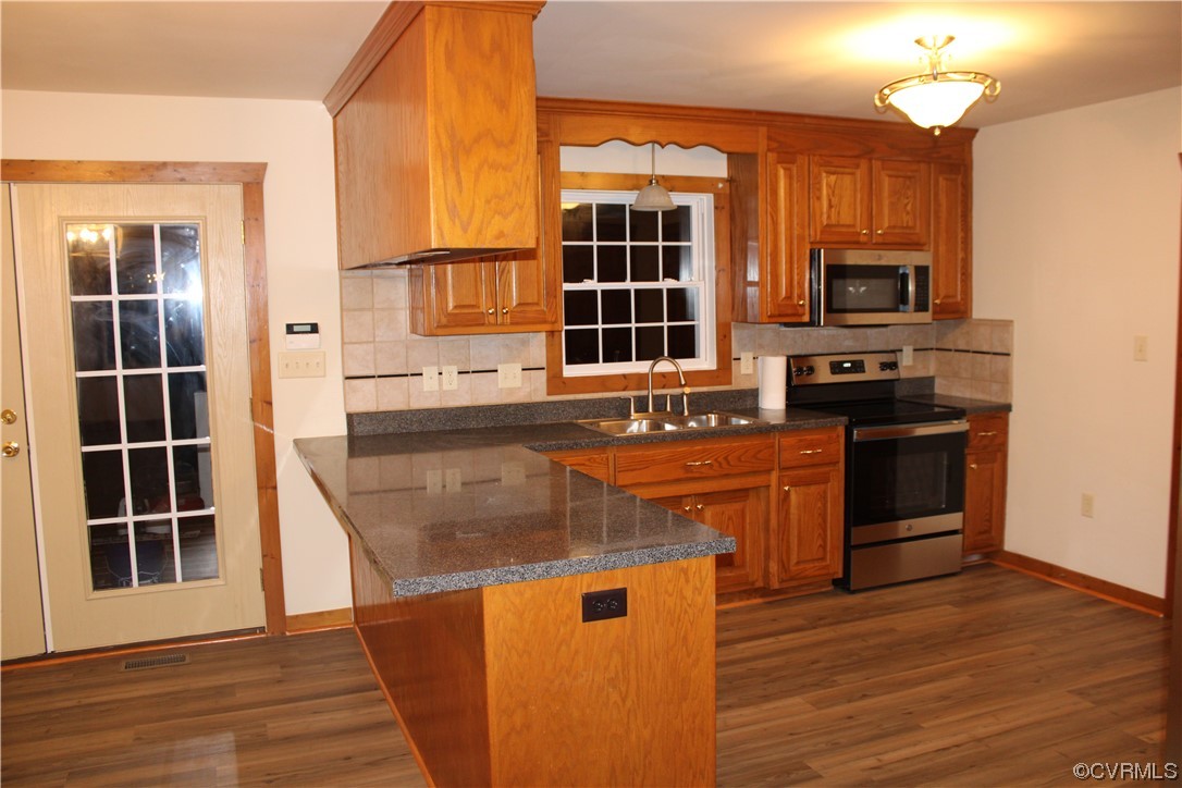 19577 Templeton Road Carson, VA 23830 - Photo 5 of 16 a kitchen with stainless steel appliances granite countertop a stove a sink and a microwave
