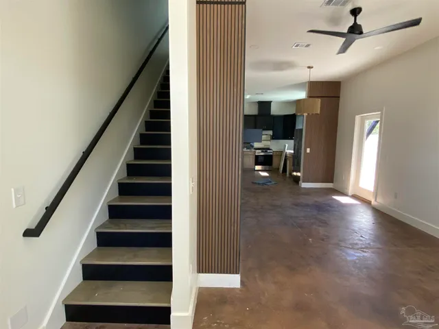 a view of entryway and hall with wooden floor