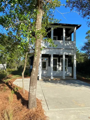 a front view of a house with parking space
