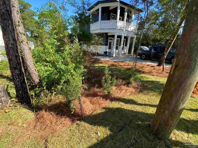 a view of a house with backyard porch and sitting area