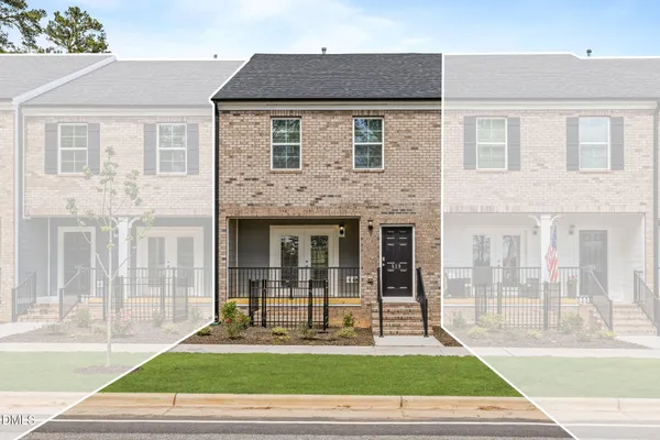 a view of a brick house with a yard in front of a house