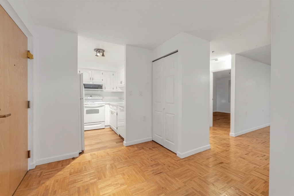 357 Commercial Street, Unit 219 Boston, MA 02109 - Photo 3 of 16 a view of a kitchen with wooden floor and a kitchen