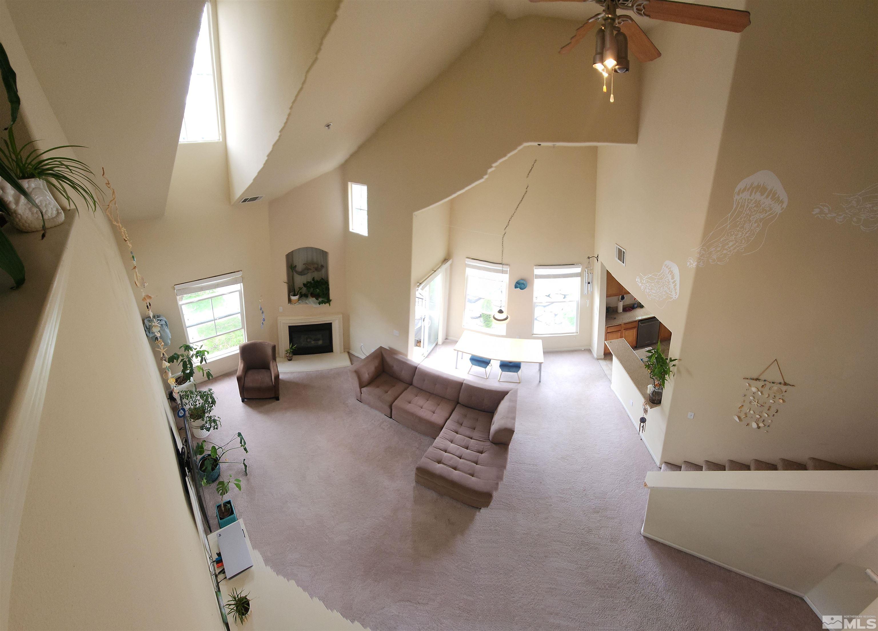 9050 Double R Boulevard, Unit 1124 Reno, NV 89521 - Photo 13 of 40 a living room with furniture and a fireplace