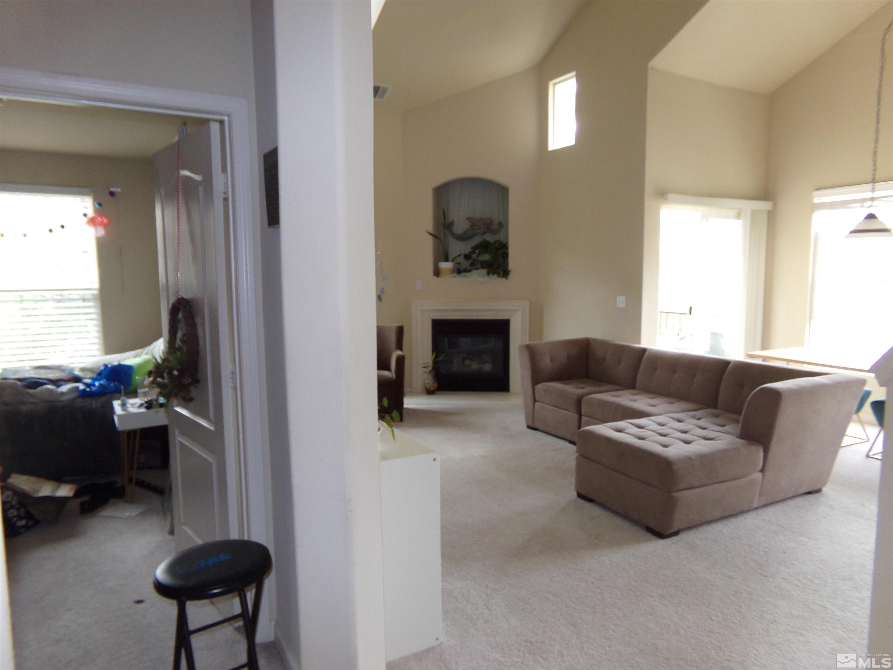 9050 Double R Boulevard, Unit 1124 Reno, NV 89521 - Photo 15 of 40 a living room with furniture and a fireplace