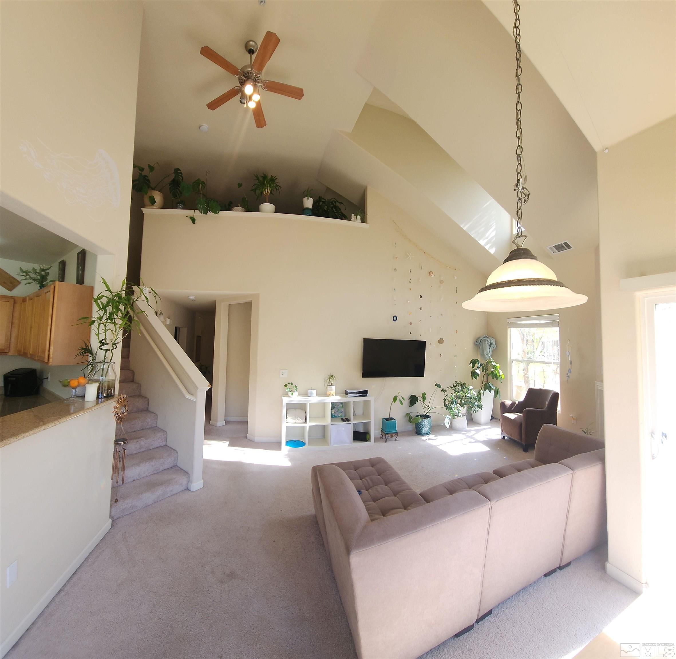 9050 Double R Boulevard, Unit 1124 Reno, NV 89521 - Photo 16 of 40 a living room with furniture and a flat screen tv