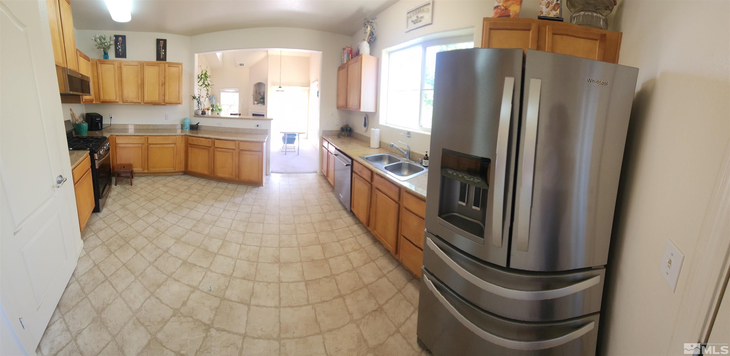 9050 Double R Boulevard, Unit 1124 Reno, NV 89521 - Photo 17 of 40 a kitchen with stainless steel appliances granite countertop a refrigerator and a sink