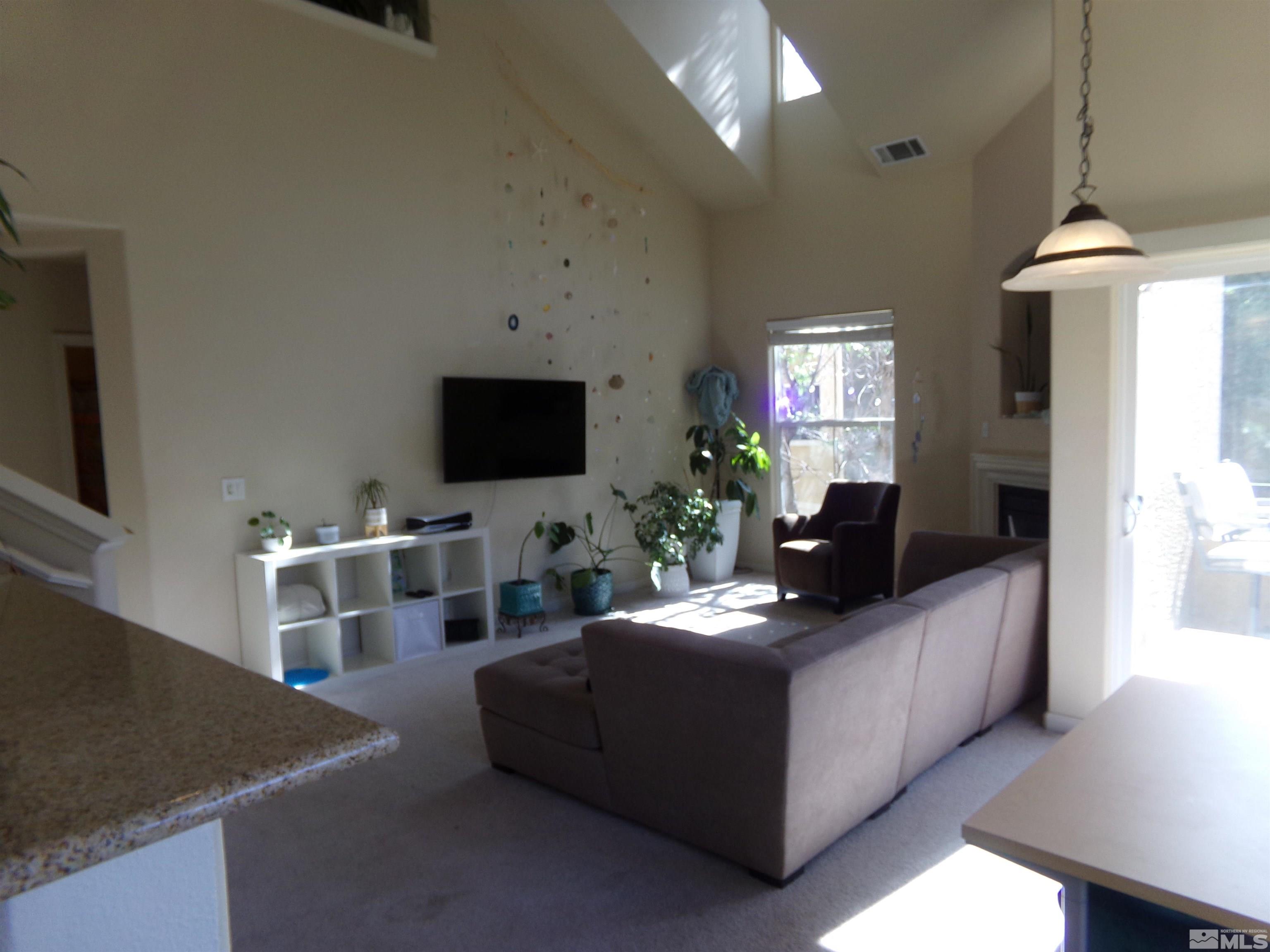 9050 Double R Boulevard, Unit 1124 Reno, NV 89521 - Photo 18 of 40 a living room with furniture and a flat screen tv