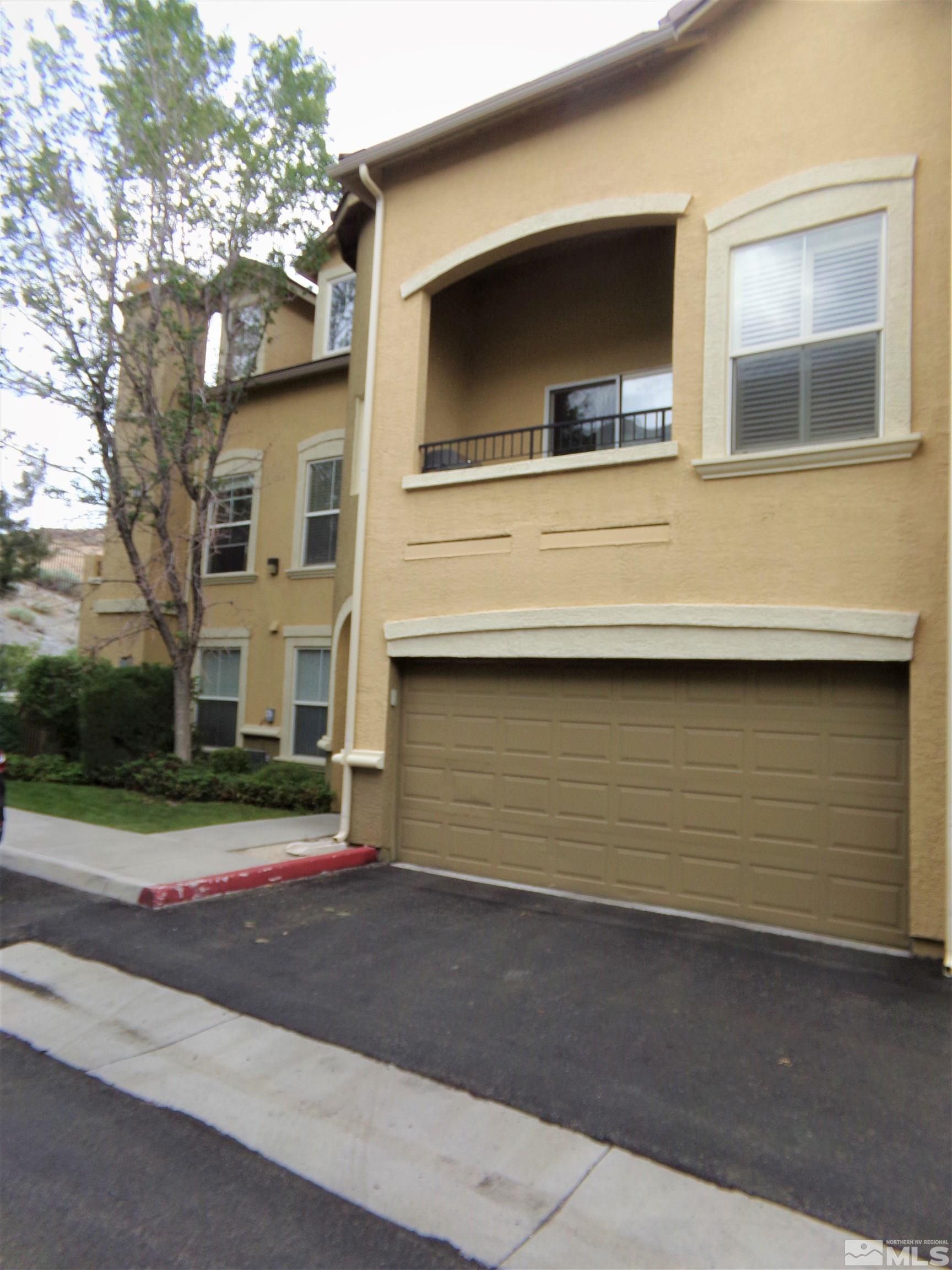 9050 Double R Boulevard, Unit 1124 Reno, NV 89521 - Photo 2 of 40 a front view of a house with a road