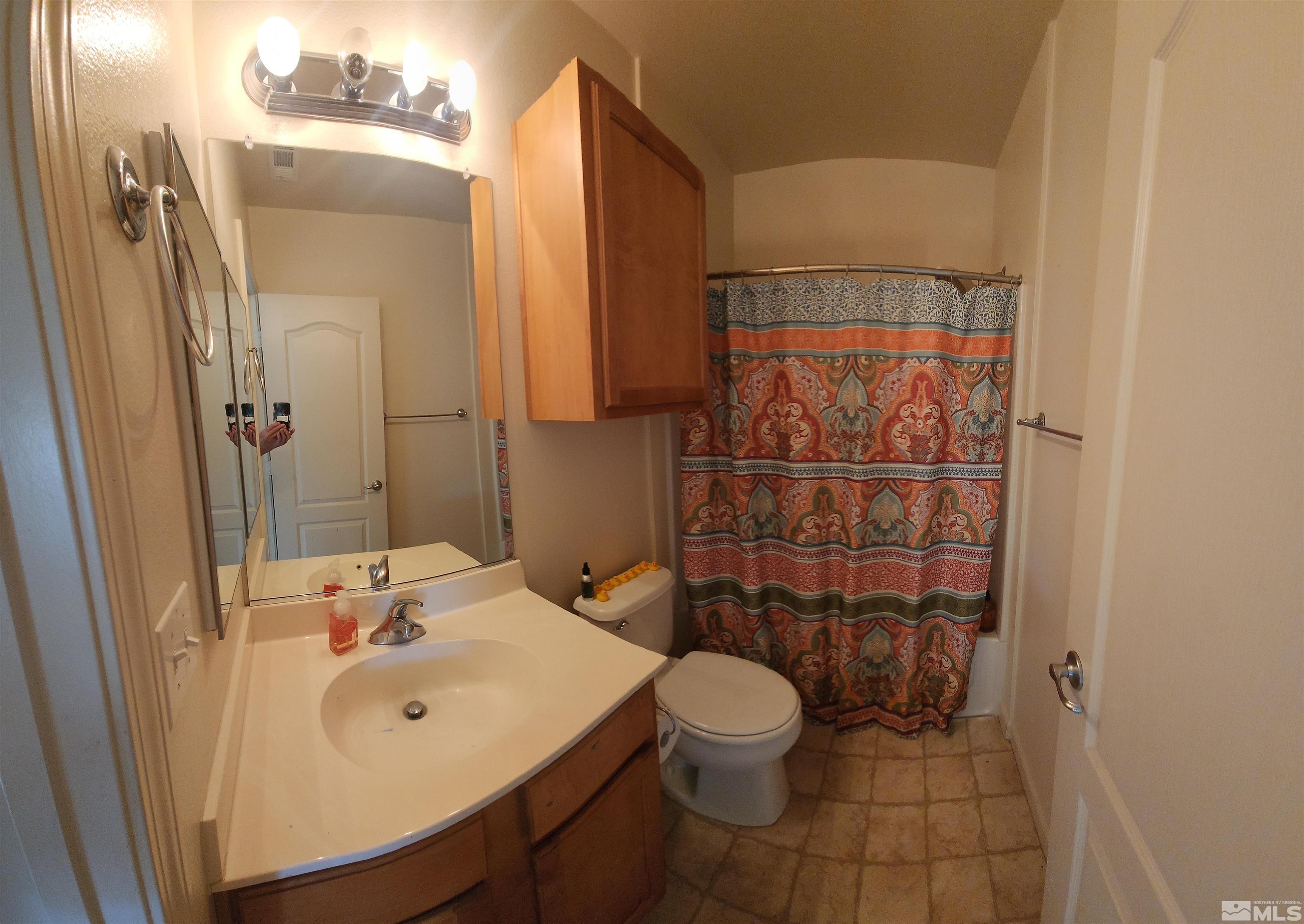 9050 Double R Boulevard, Unit 1124 Reno, NV 89521 - Photo 21 of 40 a bathroom with a sink a toilet and shower