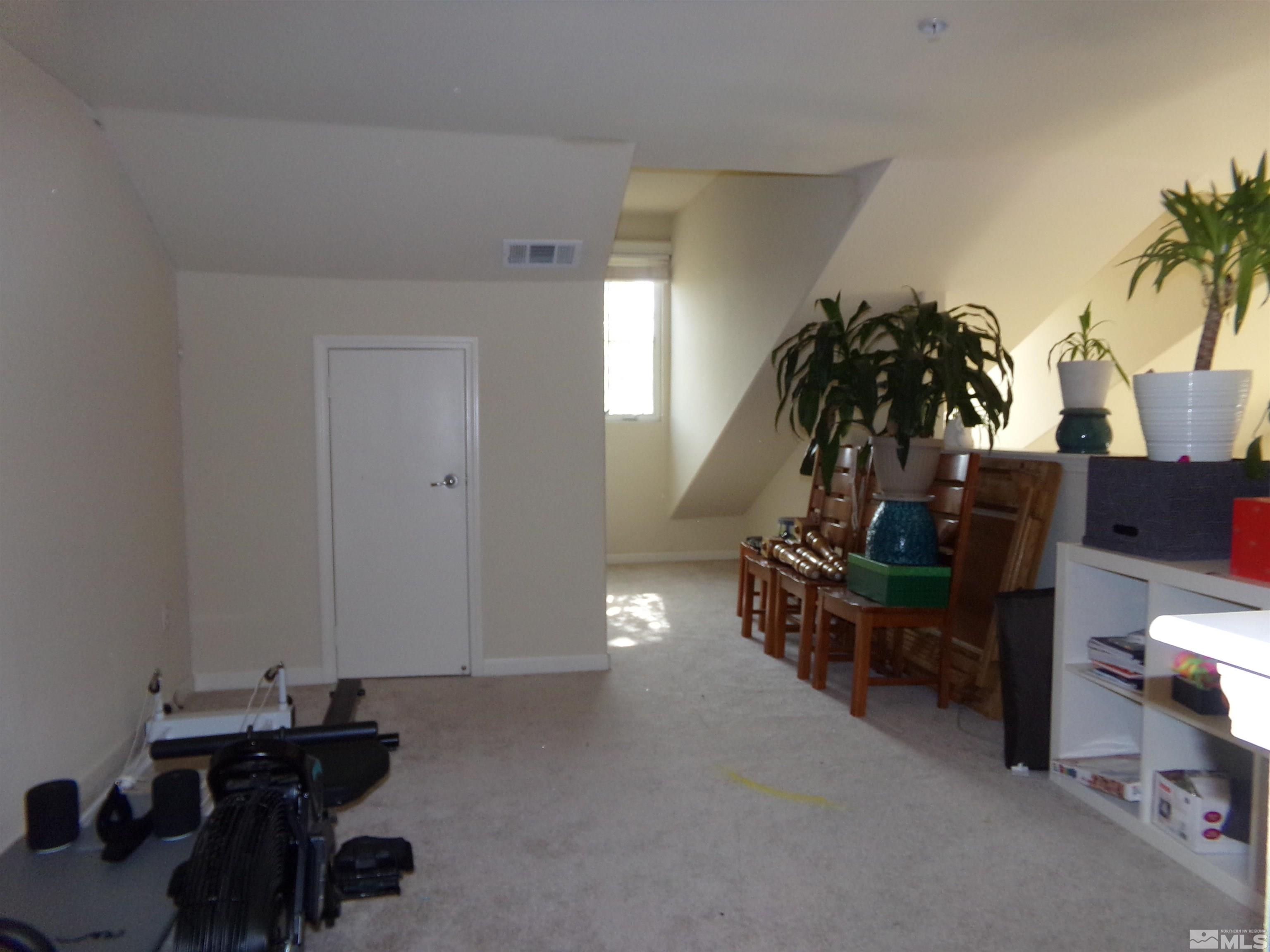 9050 Double R Boulevard, Unit 1124 Reno, NV 89521 - Photo 24 of 40 a living room with furniture and a potted plant
