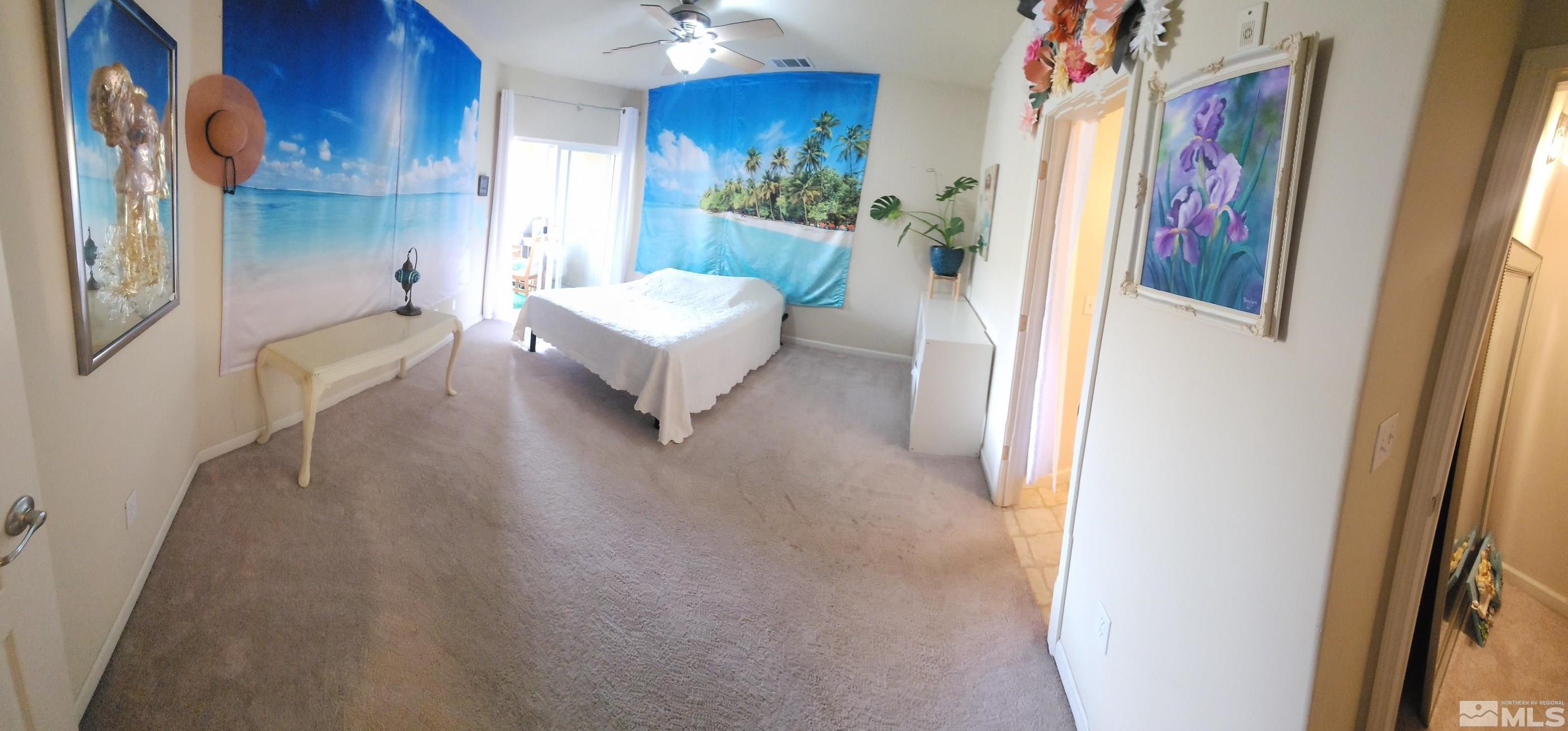 9050 Double R Boulevard, Unit 1124 Reno, NV 89521 - Photo 27 of 40 a spacious bedroom with a bed and a painting on the wall