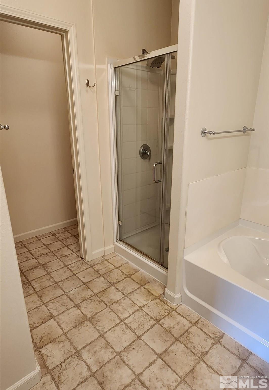 9050 Double R Boulevard, Unit 1124 Reno, NV 89521 - Photo 29 of 40 a bathroom with a shower and a bath tub