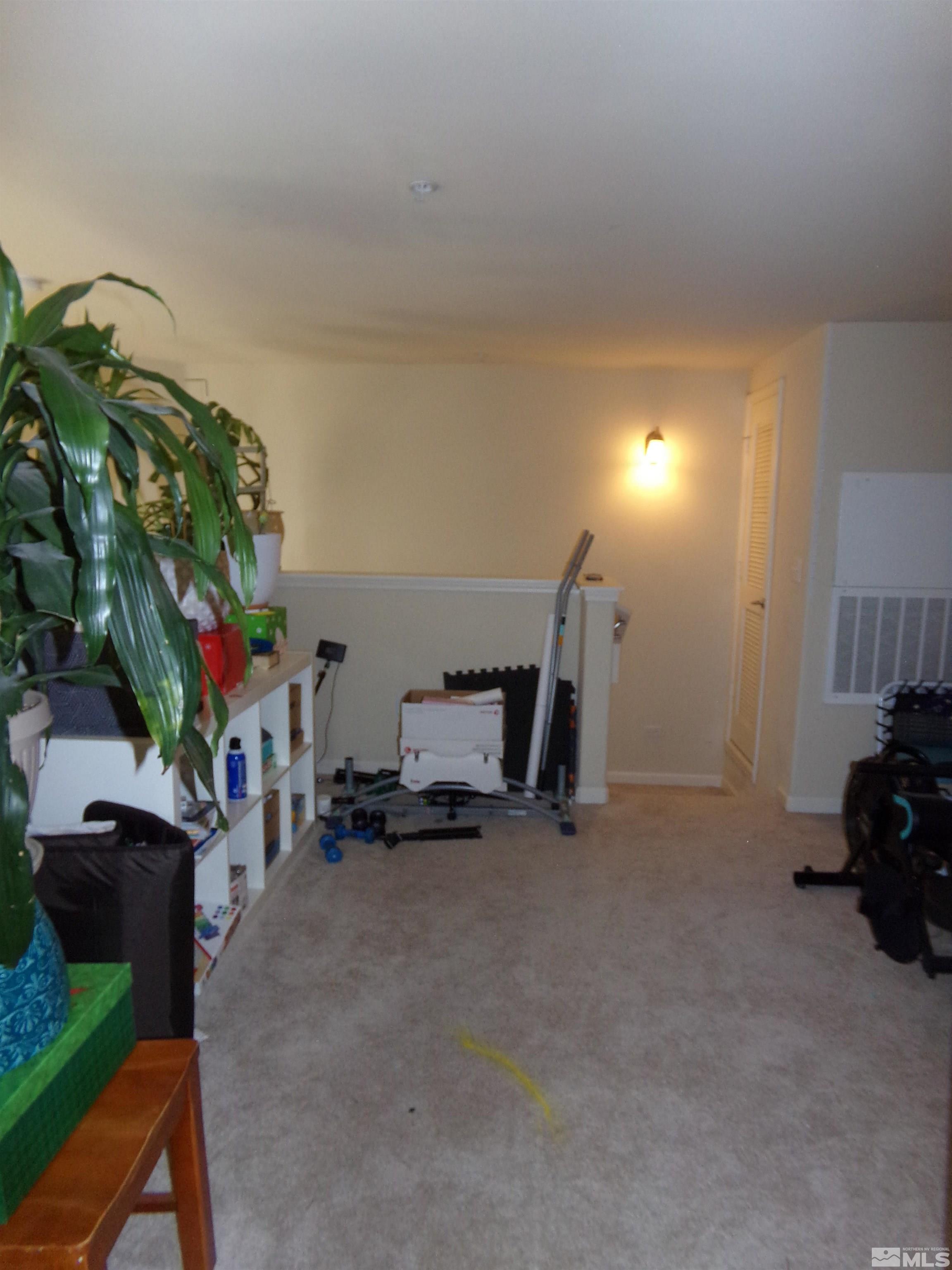 9050 Double R Boulevard, Unit 1124 Reno, NV 89521 - Photo 32 of 40 a living room with furniture and a potted plant
