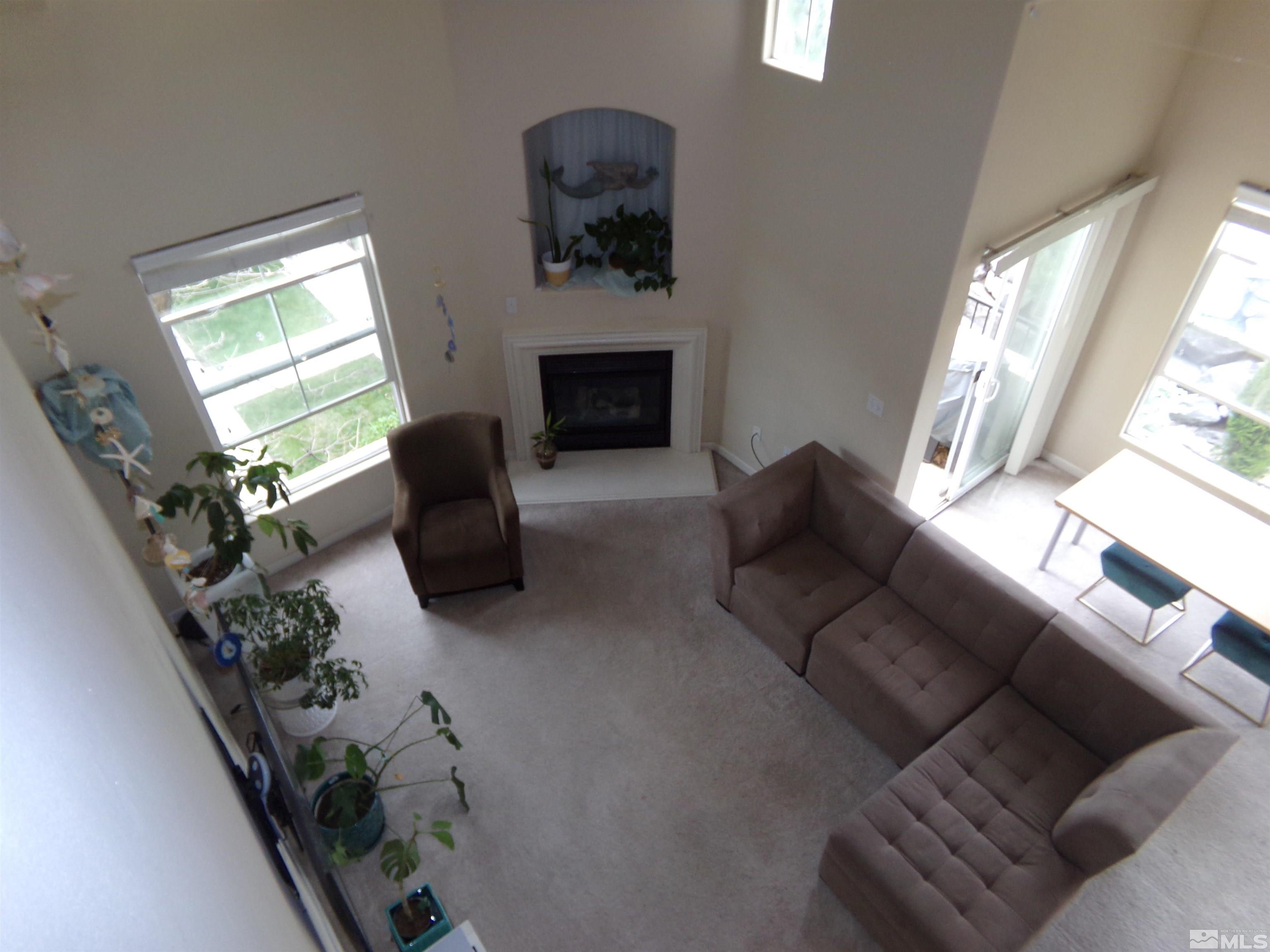 9050 Double R Boulevard, Unit 1124 Reno, NV 89521 - Photo 35 of 40 a living room with furniture and a fireplace