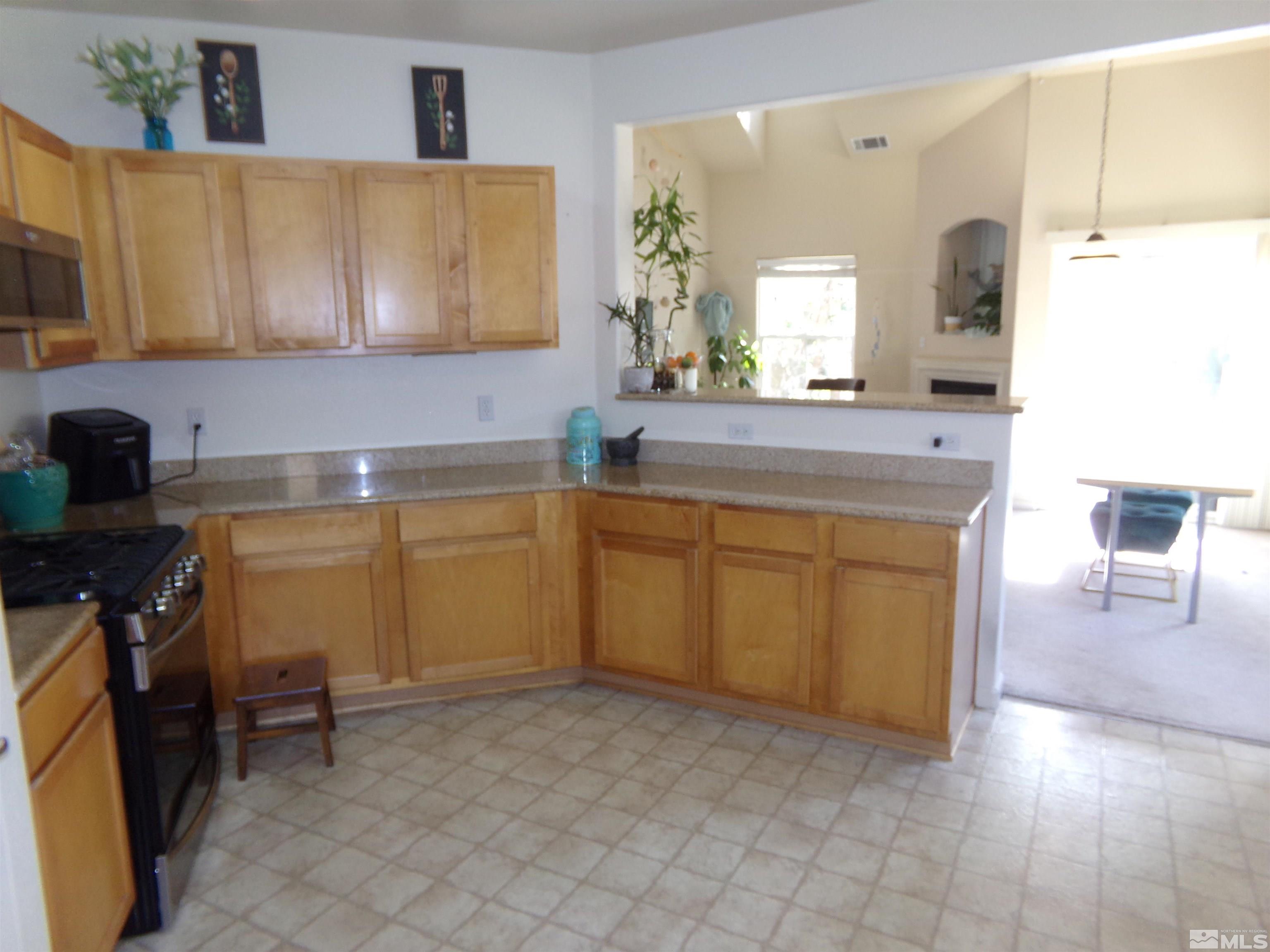 9050 Double R Boulevard, Unit 1124 Reno, NV 89521 - Photo 6 of 40 a kitchen with a cabinets and chandelier