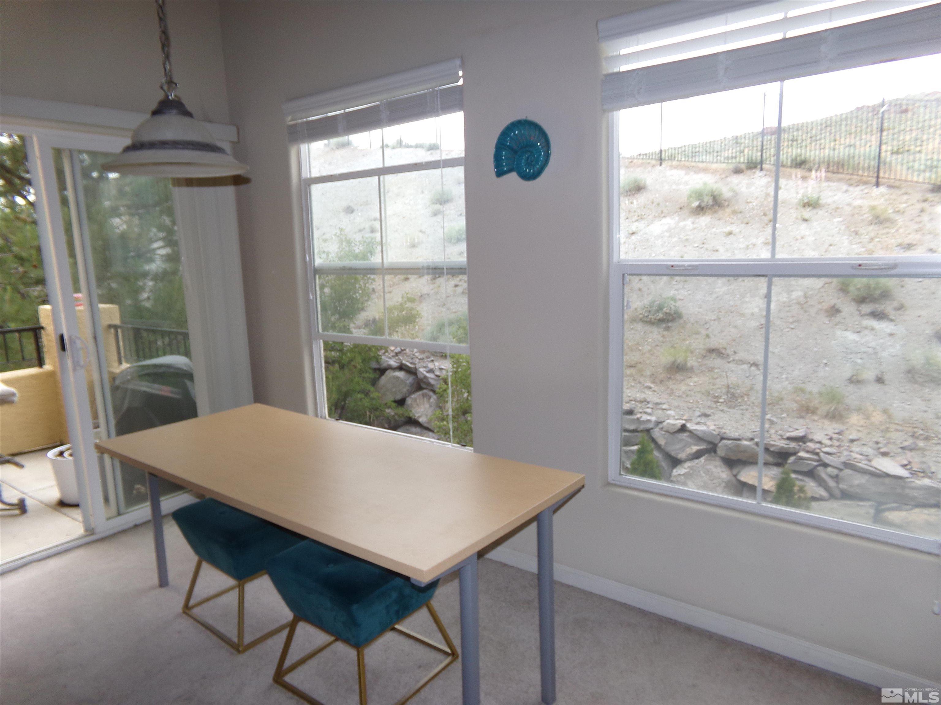 9050 Double R Boulevard, Unit 1124 Reno, NV 89521 - Photo 7 of 40 a view of a dining room with furniture window and outside view