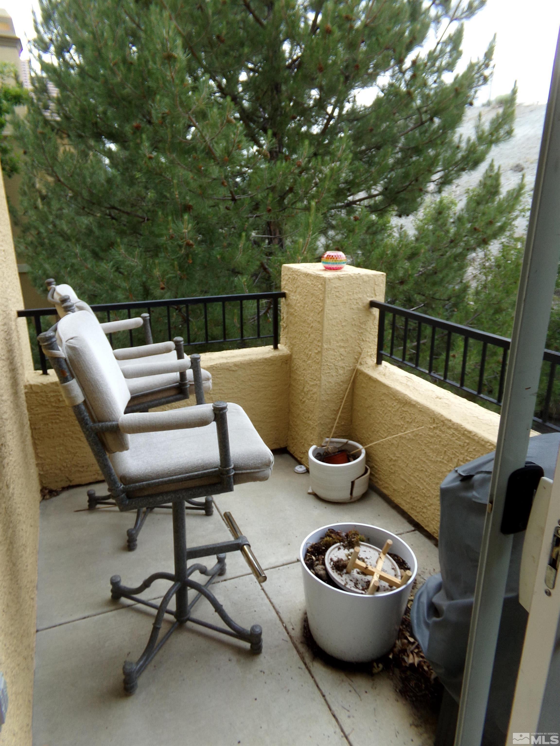 9050 Double R Boulevard, Unit 1124 Reno, NV 89521 - Photo 9 of 40 a balcony with table and chairs