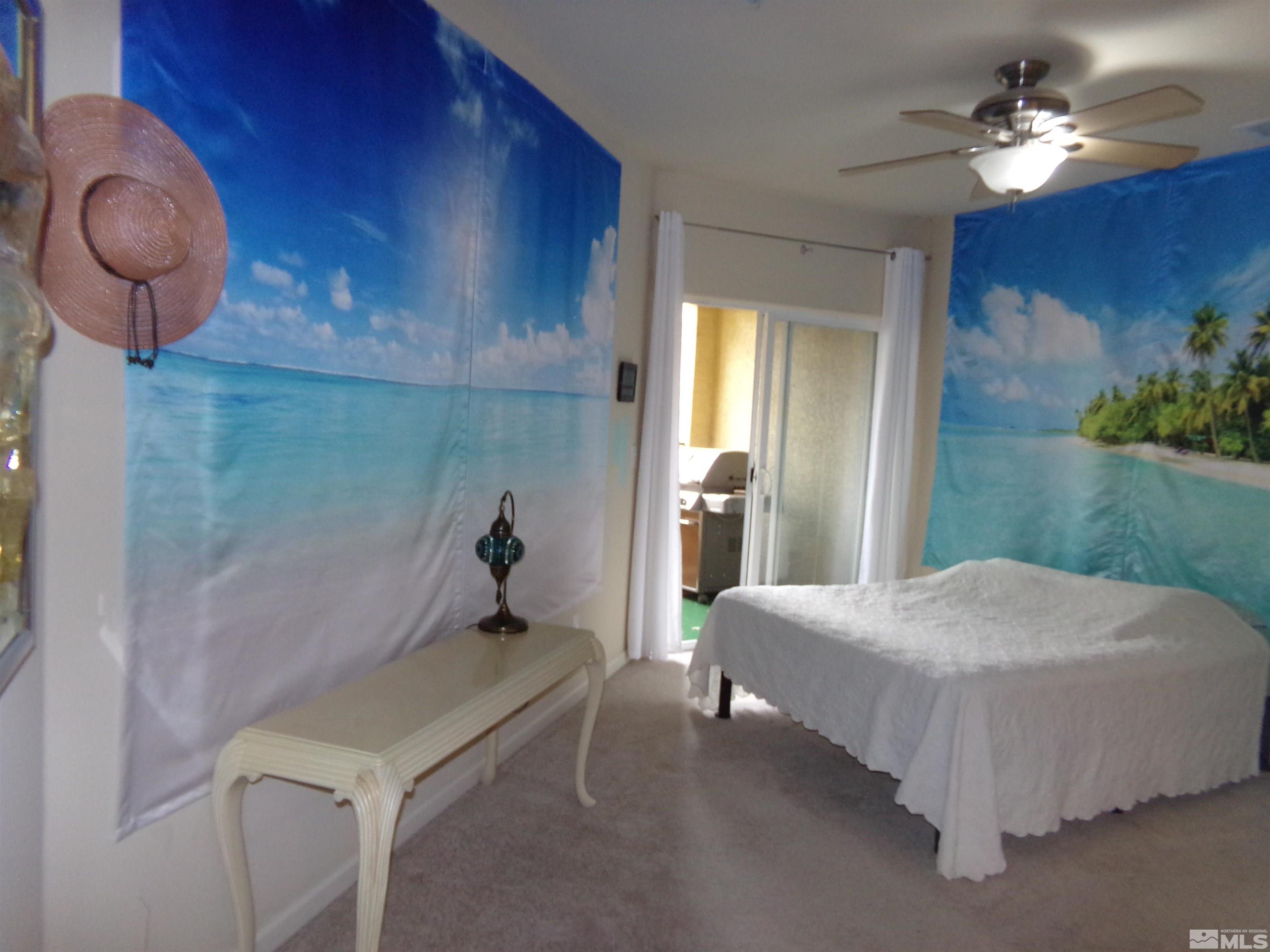 9050 Double R Boulevard, Unit 1124 Reno, NV 89521 - Photo 10 of 40 a bedroom with a bed and a chandelier