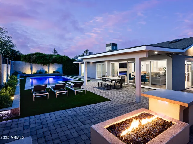 a view of a house with swimming pool and sitting area