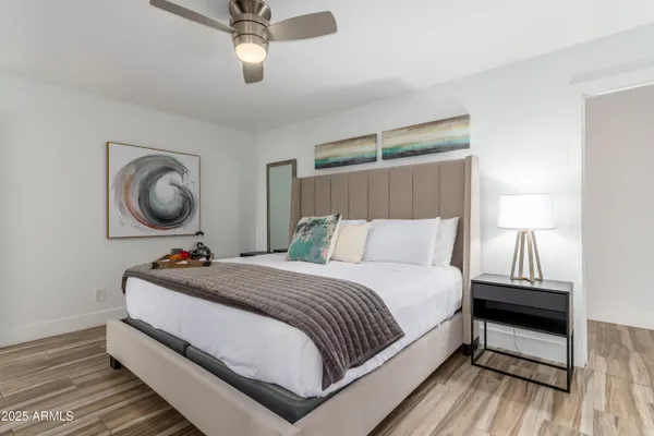 a bedroom with bed and a chandelier