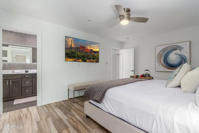 a bedroom with a large bed and a chandelier