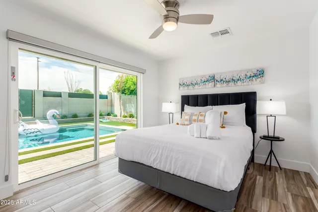 a bedroom with a bed and large window