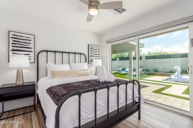 a bedroom with a bed and a view of balcony