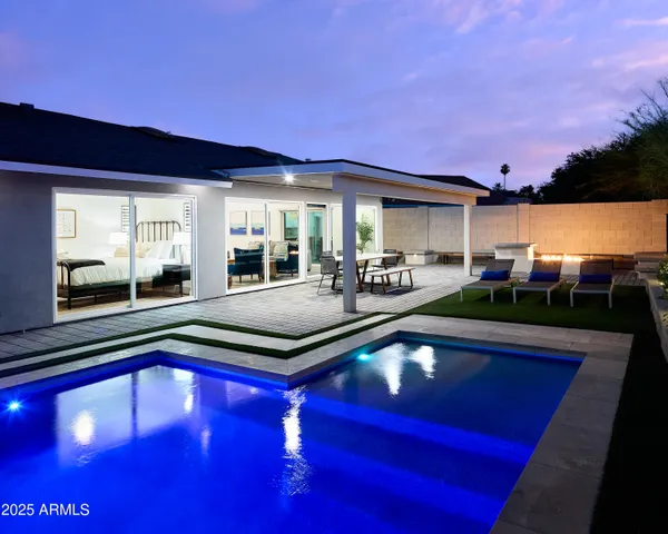 a view of open kitchen with a swimming pool and outdoor seating