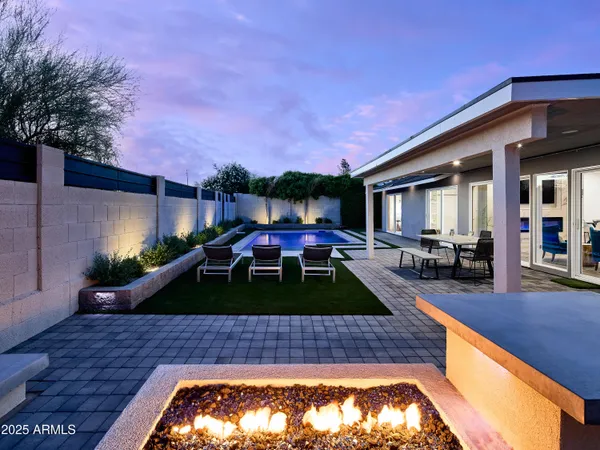 a front view of house with yard swimming pool and outdoor seating