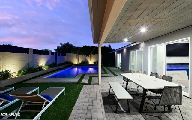 a view of a patio with table and chairs with wooden floor and fence