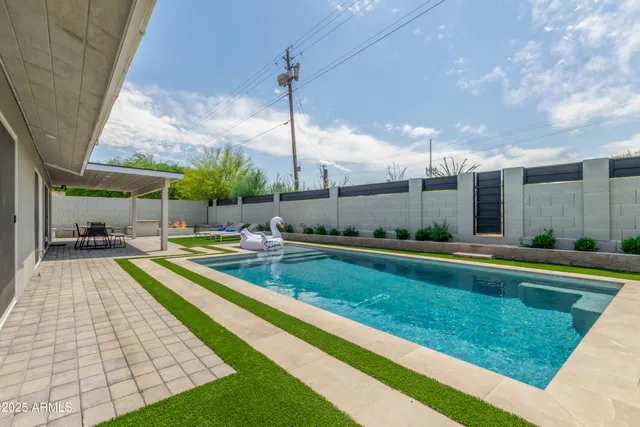 a view of a patio with a table and chairs