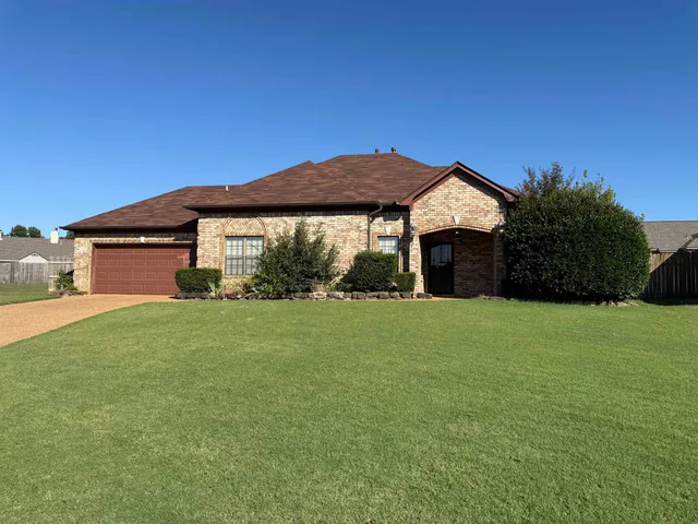a front view of house with yard and green space