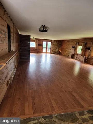 a view of room with window and wooden floor
