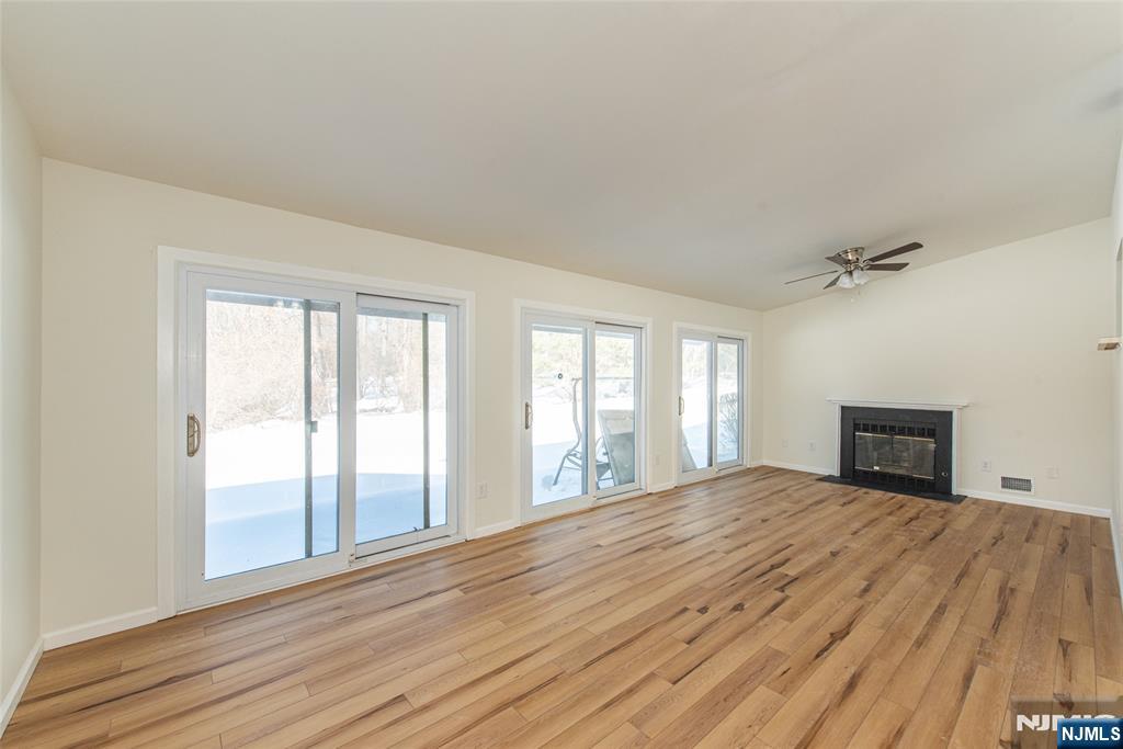 7 Summit Court Annandale, NJ 08801 - Photo 5 of 21 a view of empty room with wooden floor and fan